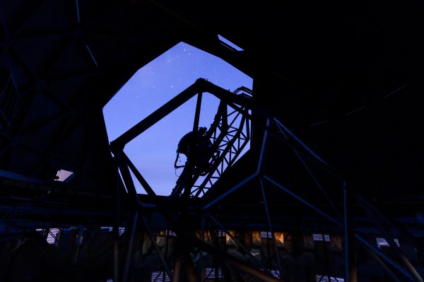 The SALT dome's shutter is open and the nighttime sky reveals a few stars, the silhouette of the struts are clear.