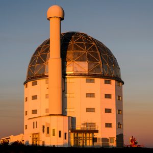 A dramatic exterior of Southern African Large Telescope at sunset.