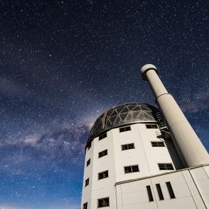 A nighttime long exposure of Southern African Large Telescope showing a sky filled with stars and the Milky Way Galaxy.