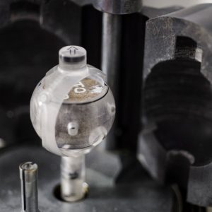 A special instrument holds a circular rock core.