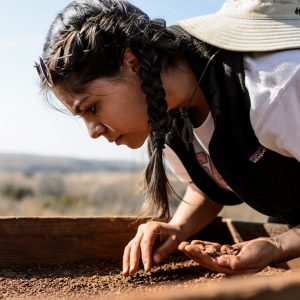 UW-Madison student Talia Sankari uses a sifting screen to sort for potential artifacts