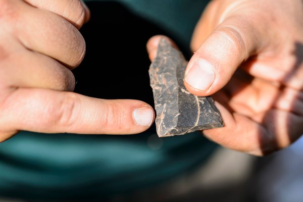 University of the Witwatersrand postdoctoral researcher Matt Caruana points out the hammered-edges of a middle-stone age point